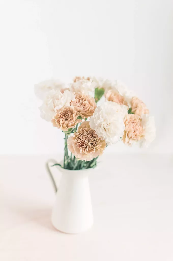 fleurs dans un pichet blanc